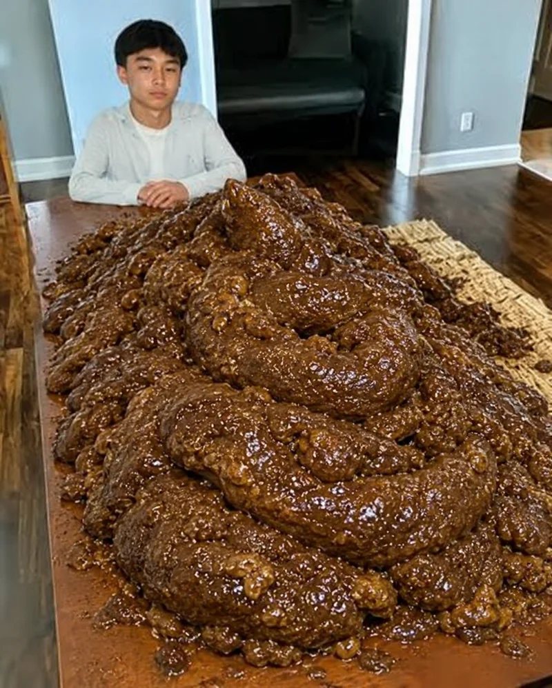 The original meme: a calm person seated behind an enormous brown mound on a dining table